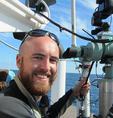 Conor Ryan with sunglasses on his head on a research ship