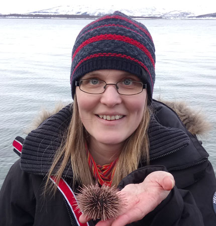 Dr Helena Reinardy holding sea urchin on her hand in the Arctic