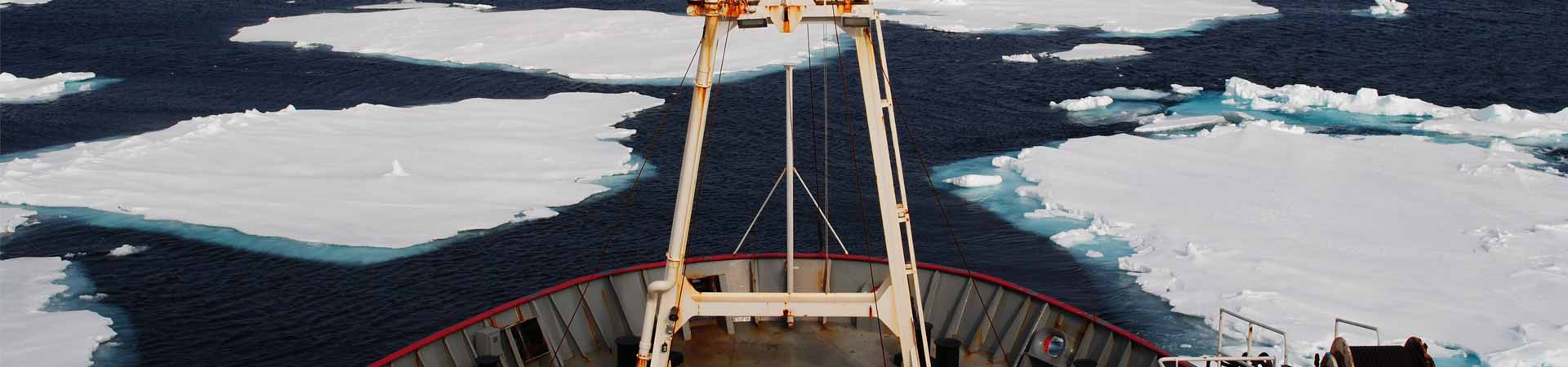 View from bow of a research vessel sailing though Arctic Ocean with sea ice