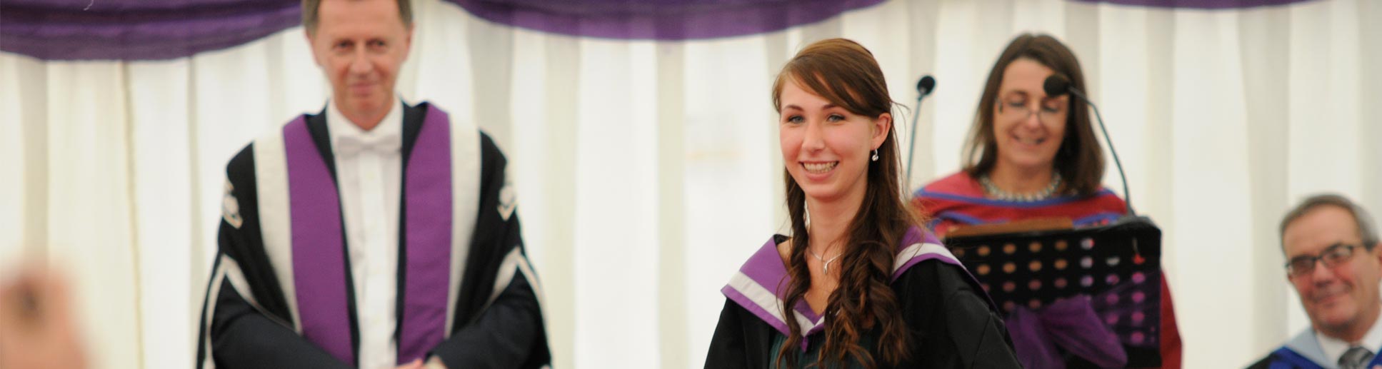 Image showing happy young student receiving her graduation certificate