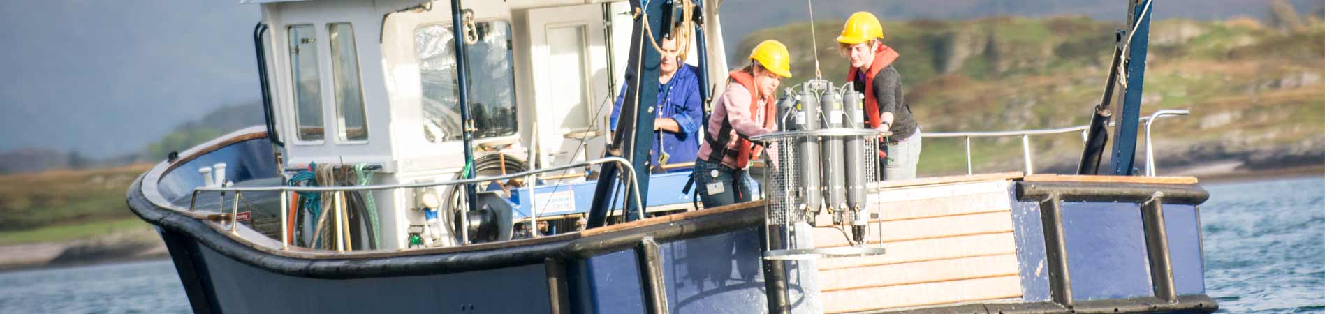 View of our small research vessel from rear showing recovery of our water sampling rosette with CTD