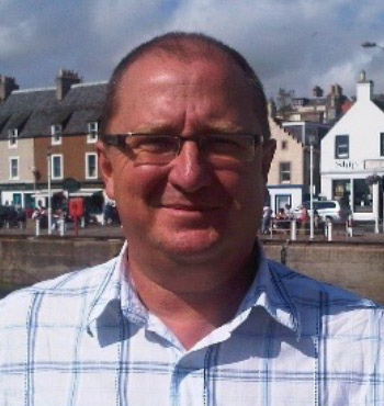 Bill Turrell wearing glasses and a white shirt