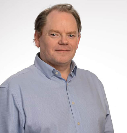 Corporate headshot of Alun Williams wearing a grey shirt