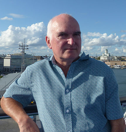 Alun Williams pictured near the sea wearing a blue shirt