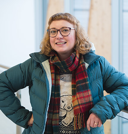 
        Iona Harvey wearing a jacket and scarf
        