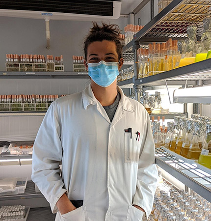 Picture of PhD student Alberto Rock wearing a lab boat and face mask