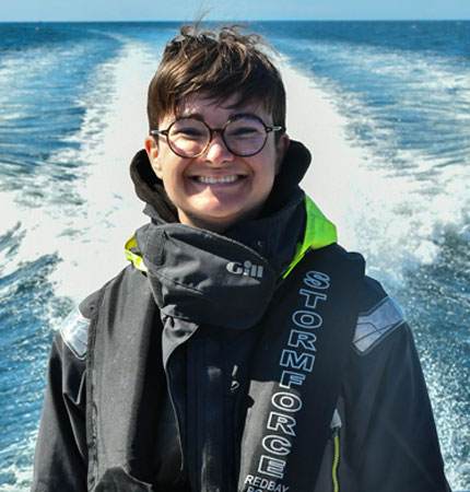 Head and shoulder photo taken on a boat with sea in the background