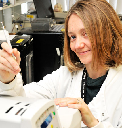 Dr Arlene Ditchfield in the laboratory injecting a sample into a gas chromatograph