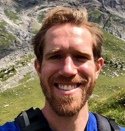 Head shot of smiling Dr Tim Szewczyk during a hill walking trip