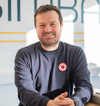 Head and shoulder image of Dr Mark Hart outside at the back beach