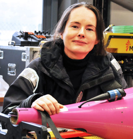 
        Marine robotics technician Estelle Dumont with a sea glider in the Scottish Marine Robotics Facility
        