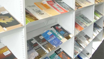 Research library photo showing scientific journals on shelves