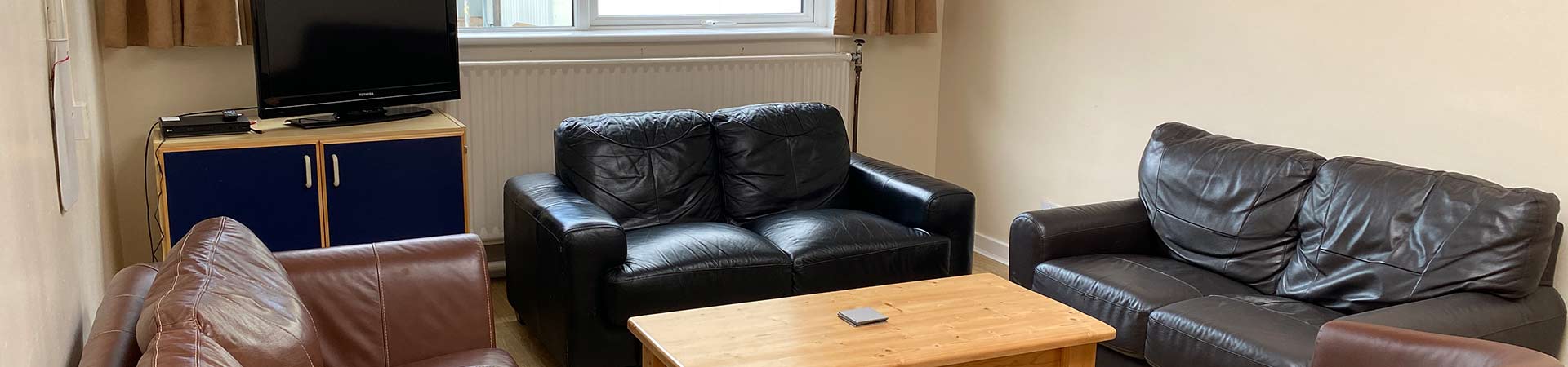 Student in Margaret Barnes residence living room relaxing