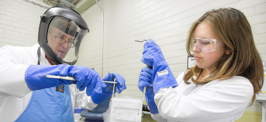 student helping researcher with cryopreservation