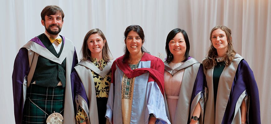 Graduation students laughing in their robes
