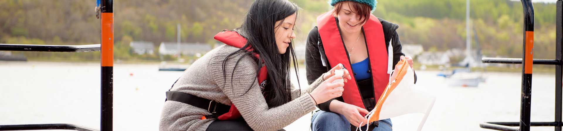 Students collecting plankton samples with plankton net off the SAMS pontoon