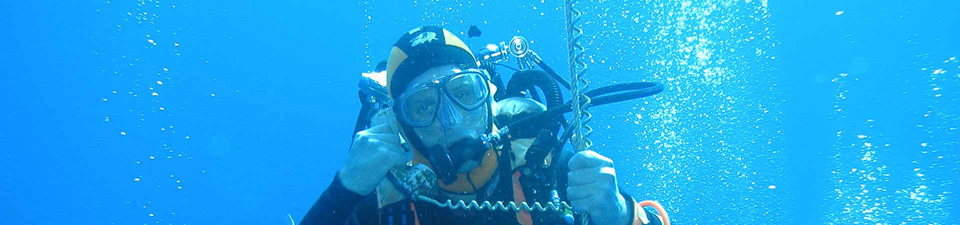 Photo showing diver messing around with an old fashioned phone to encourage students to get in touch