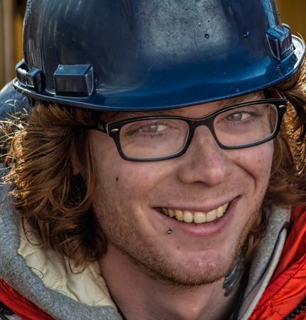 Photo showing a smiling Dr Jordan Grigor wearing a hard hat