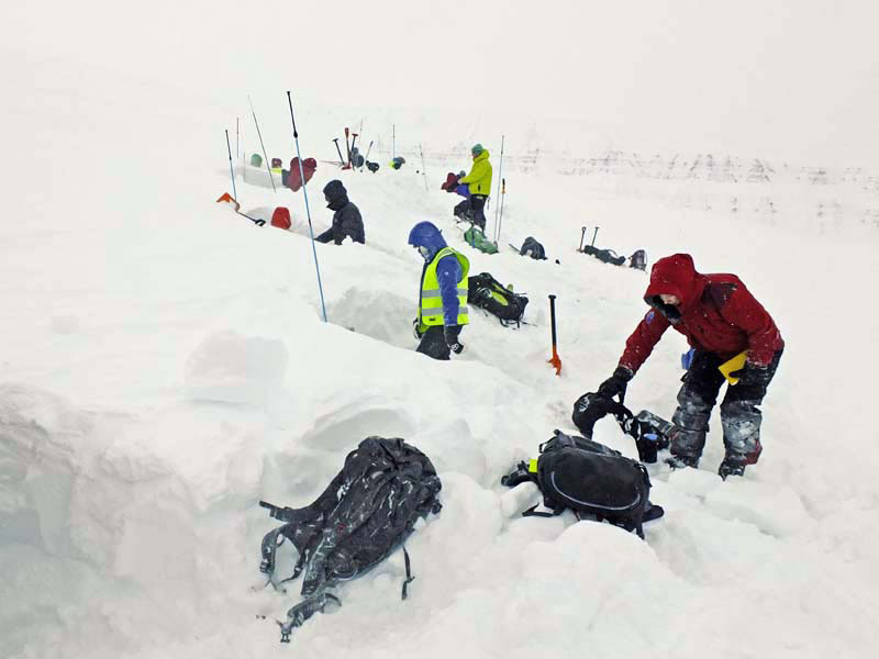 Digging snow pits to study layering for geophysics course 