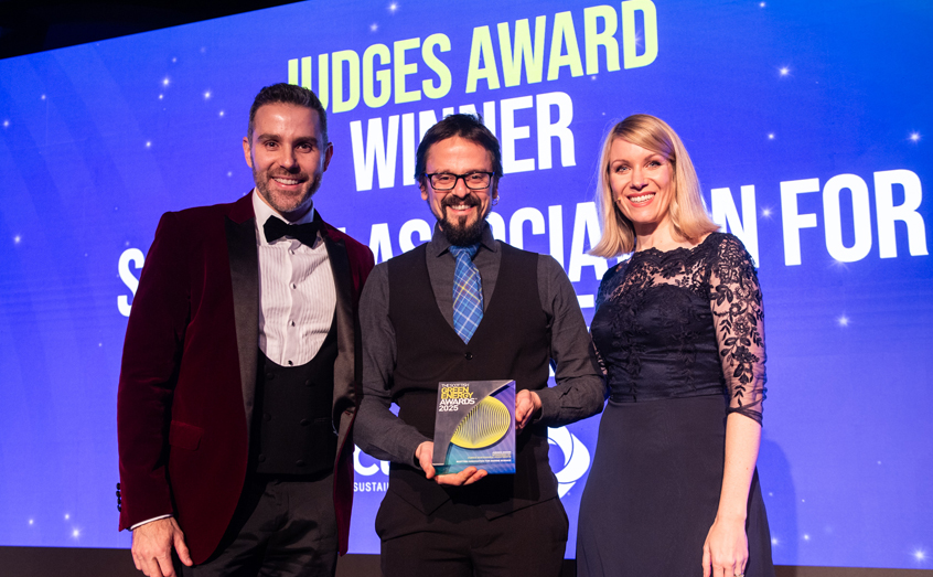 Daniel Carcajona, business development manager at SAMS Enterprise, receives the Judges Award from Lucas Pegoraro, from award sponsor Cubico Sustainable Investments, and one of the event hosts, Rachel Parris