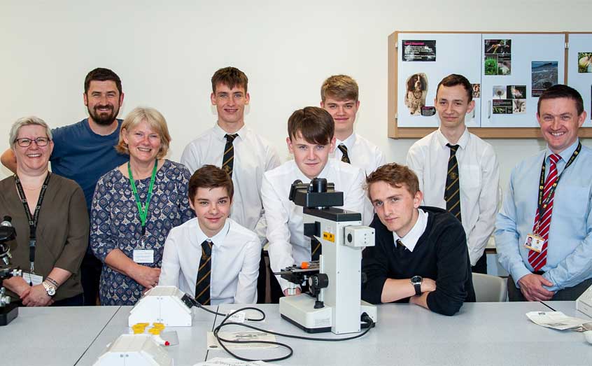 SAMS technical resource manager Christine Campbell and technicians Elaine Mitchell and Lars Brunner donated three research-grade microscopes to Oban High School's head of science Iain Fulton.