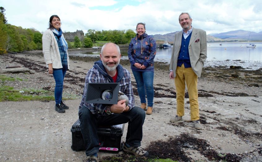 SAMS filmmaker Andy Crabb takes delivery of the Sulis underwater camera as Prof Bhavani Narayanaswamy, Sarah Reed and Prof Nicholas Owens look on
